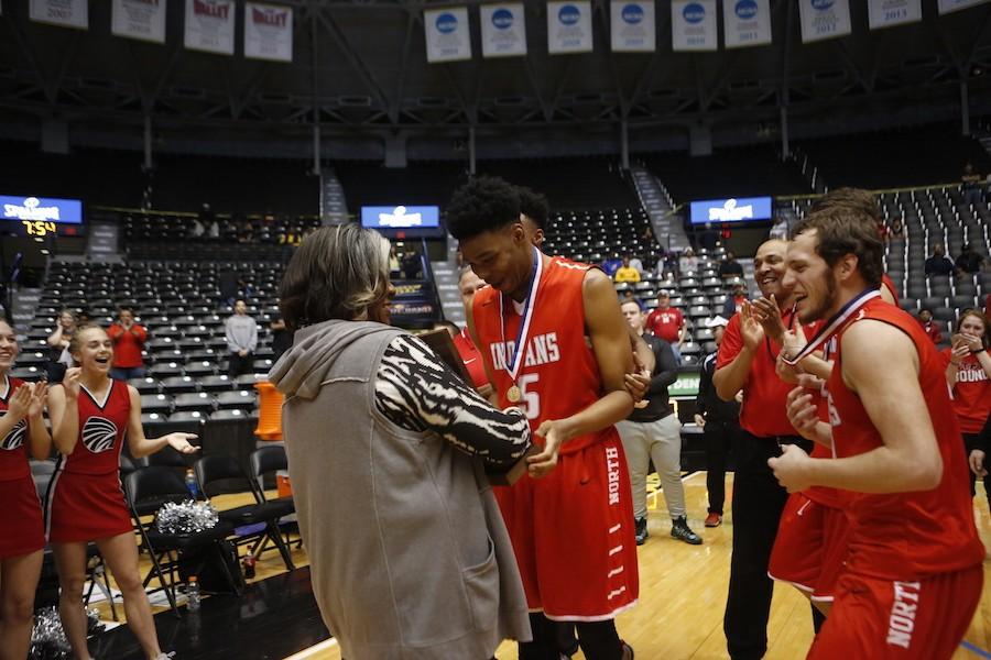 Senior Marcus Weathers is presented with the 6A state title plaque.
