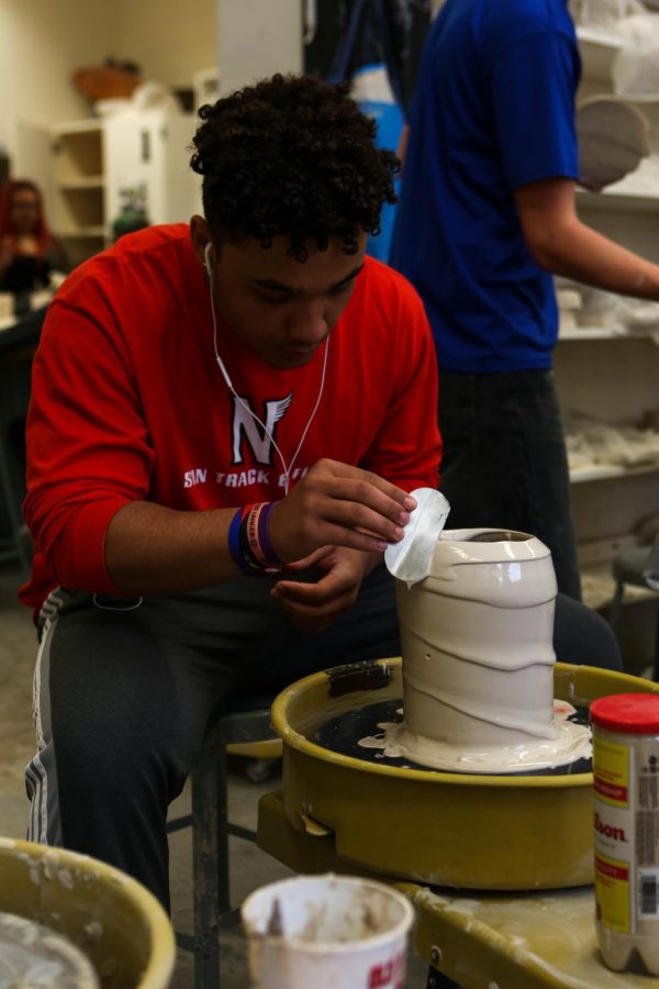 As senior Reese Sila evens his vase out, he works to get the right pattern.