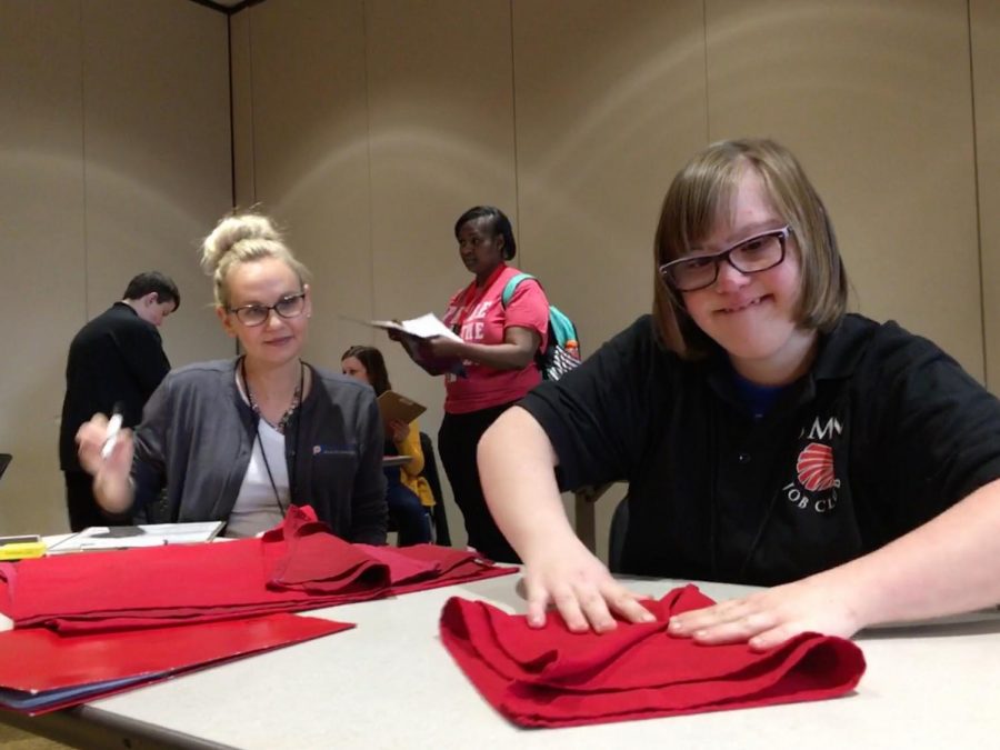 Senior Katie Saesnick participates in the napkin folding competition at the annual Job Olympics event March 28.