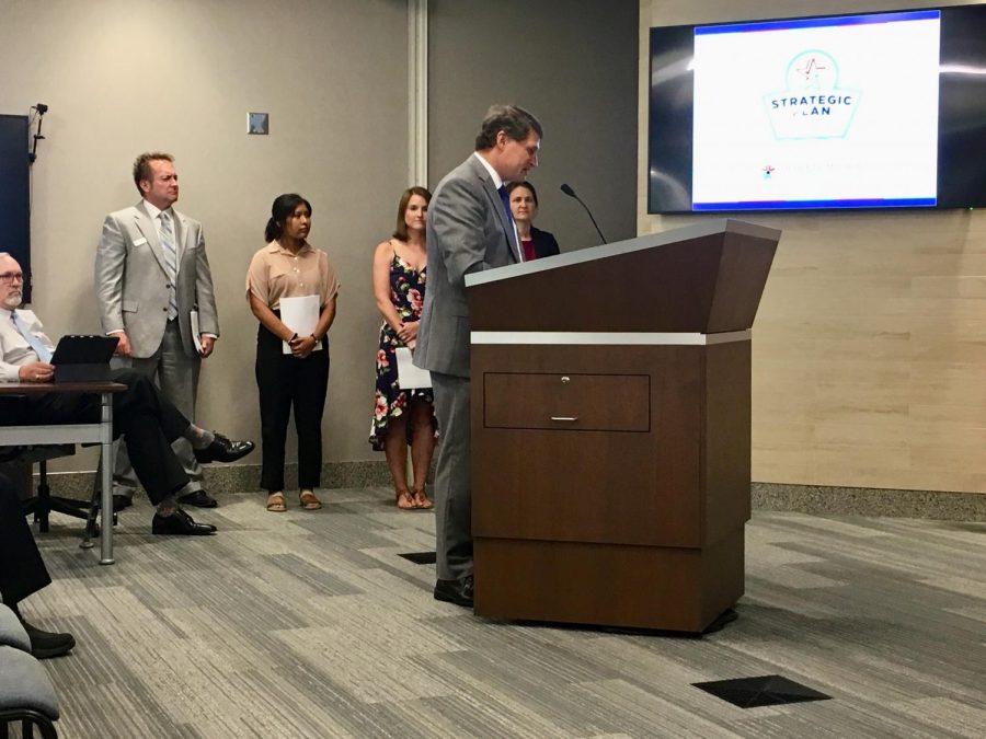 Superintendent Michael Fulton unveils the districts new strategic plan with the help of parent, teacher and student representatives from the steering committee.