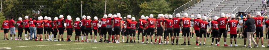 SMN football players stand in a line at the end of the game instead of shaking hands with opposing team. 