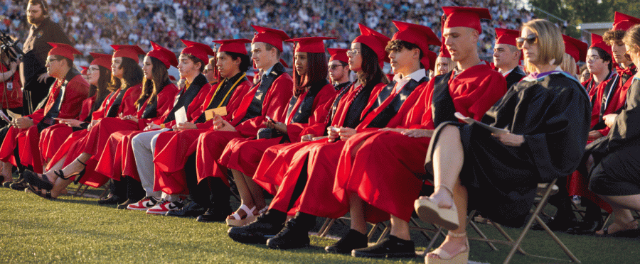 Seniors sit in rows as they wait to walk across the stage.