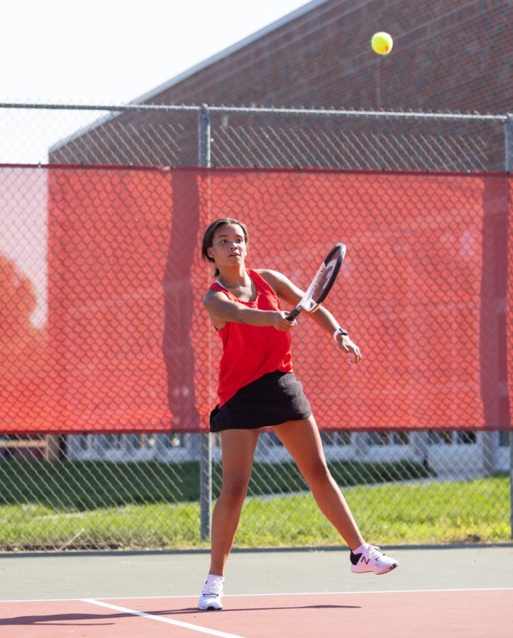 Hitting high, Junior Addison Dasilva plays tennis during the Fall Sports. It was a lot of fun! Dasilva said. There were a lot of people there to support all sports teams.