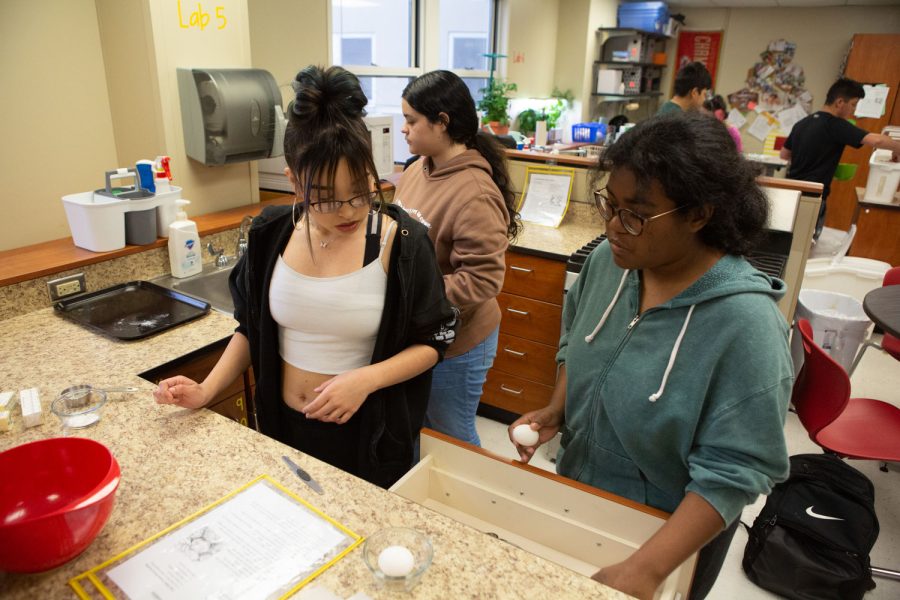 Starting the lab, Sophomore Yesenia Morales makes sugar cookies with her classmates. Morales preps for the lab by looking at instructions and pouring ingredients. Morales said she likes the lab, “ I really like the lab, I enjoyed the cookies a lot, they were really good.