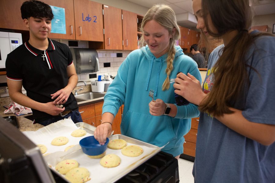 Flattens cookies, Sophomore Madison Bruson flattens the cookies to finish them off. Bruson said this experience really helped her with her cooking skills, “Overall the lab really helped me improve my baking and I had a lot of fun.