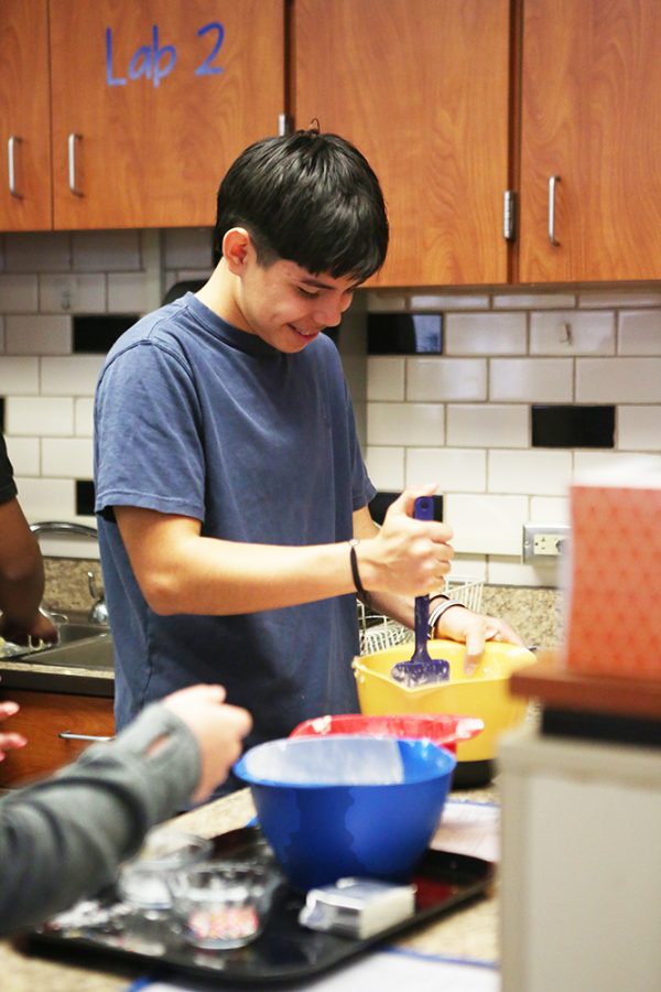 Waiting for the rest of his partners, freshman Leonardo Rebollo practices for his final. While his other classmates grabbed the rest of the ingredients Rebollo mixed the butter to prepare it for the cookies. “I was a little bored, Rebollo said but my friends were making me laugh.