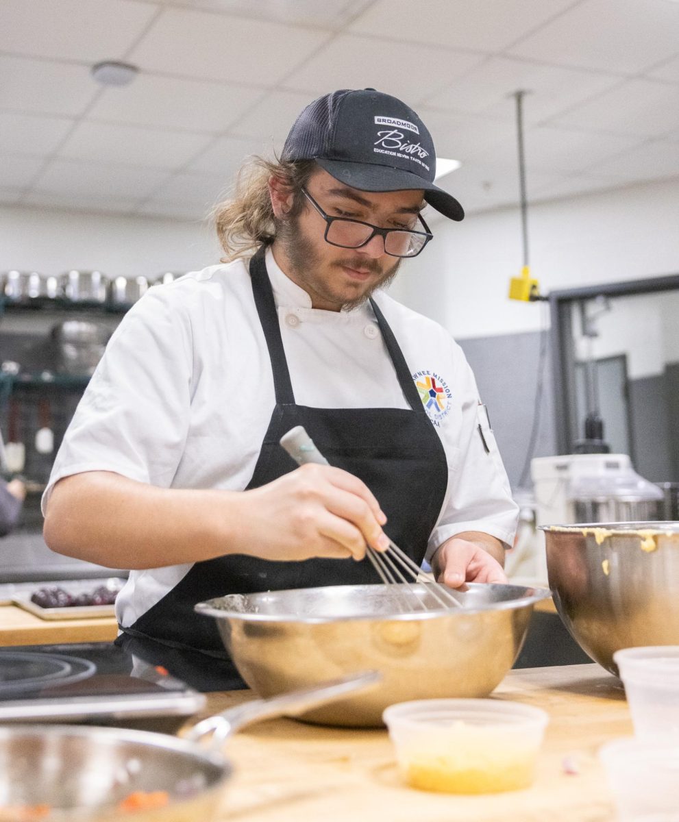 Scraping the bowl, junior Johnathan True whisks together a baking project during class on Jan. 27. During class, True and other baking students competed in a contest with a reward of free tuition to the Culinary Institute of America.