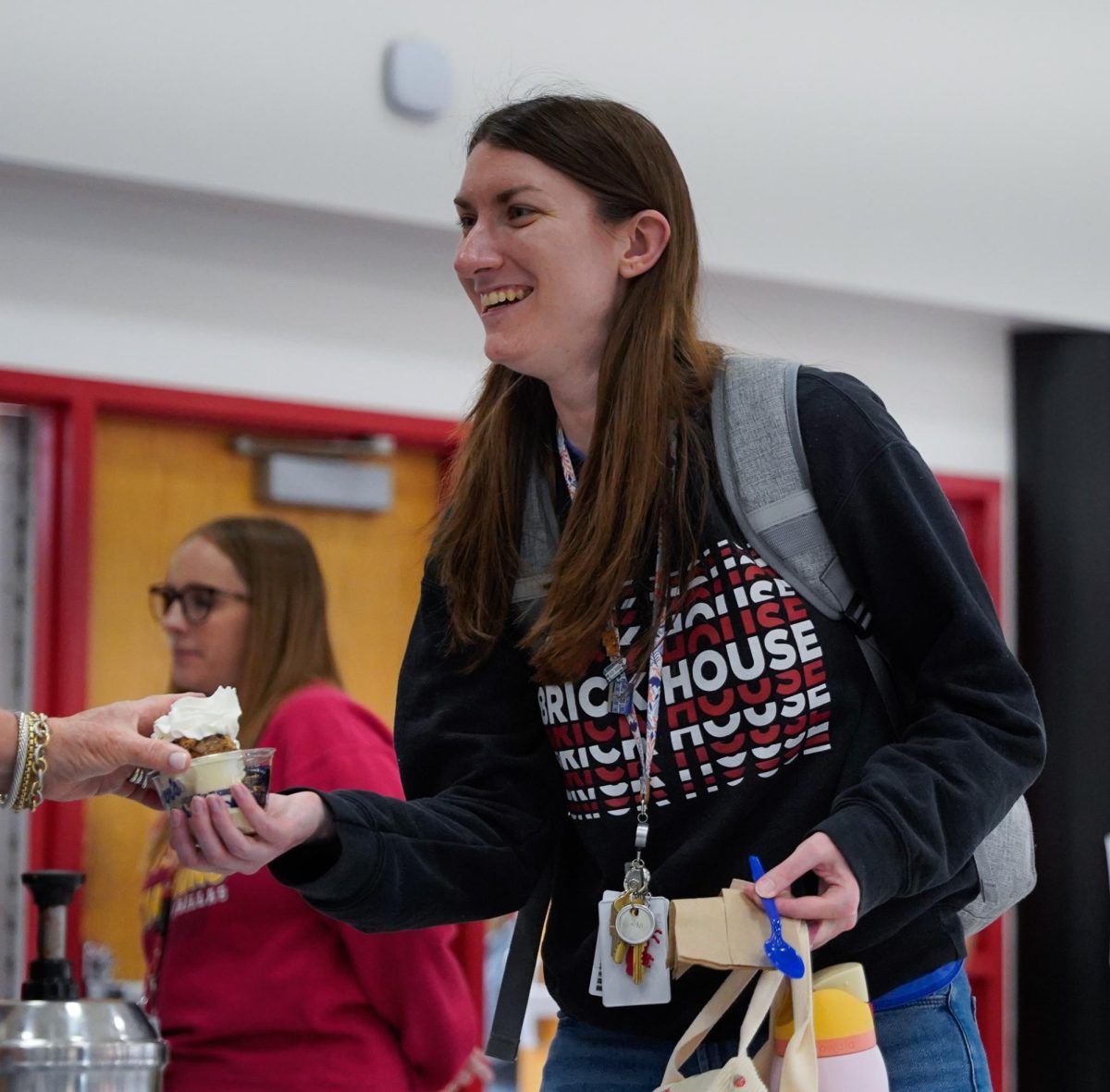 Smiling, teacher Monica Morris receives an ice cream from a Culver’s employ that was helping serve ice cream to the SM North teachers and staff. “It’s one of my favorite Teacher Appreciation Week activities! It’s a great time to get to see other staff members, plus the ice cream is always delicious,” Morris said. 